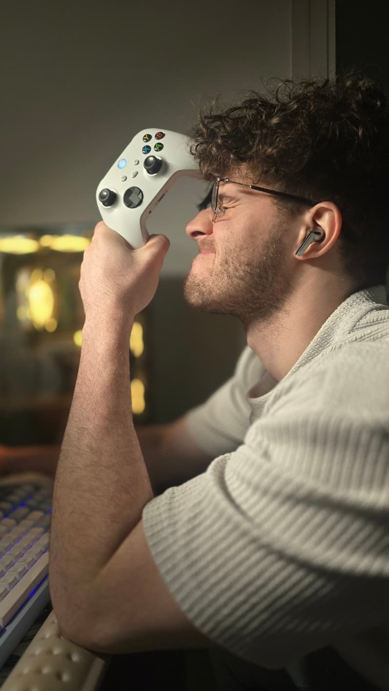Mikael pressing a controller to his forehead after a lost Rocket League match